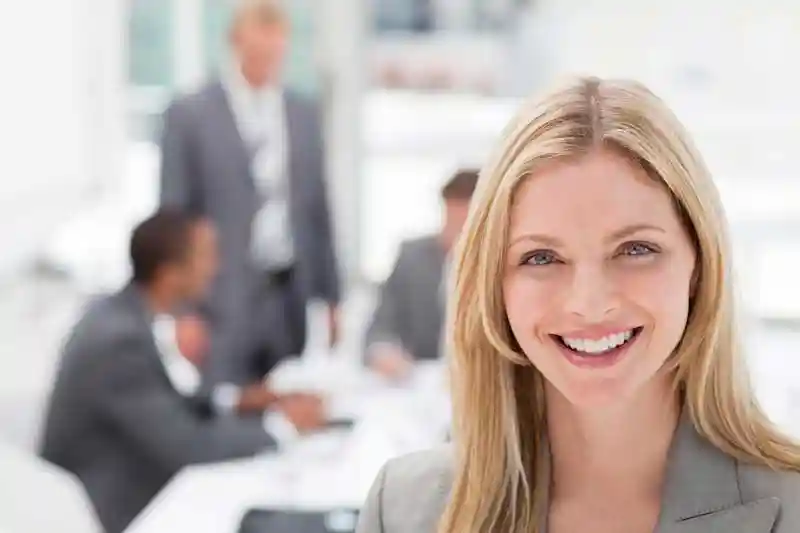 Human Resources manager with employees in background