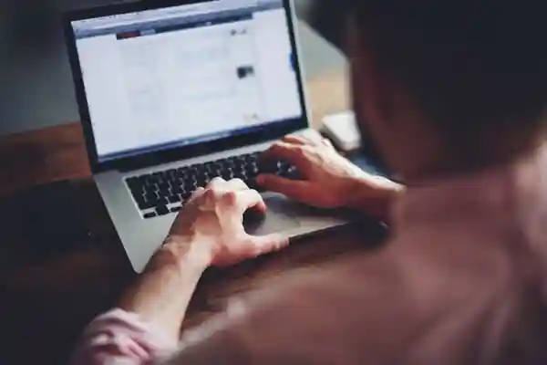 Man looking at access logs on his laptop